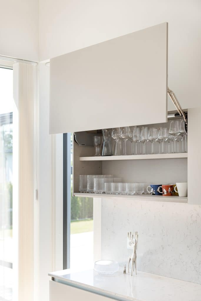 Tyylikäs keittiö, lasit hyllyllä.