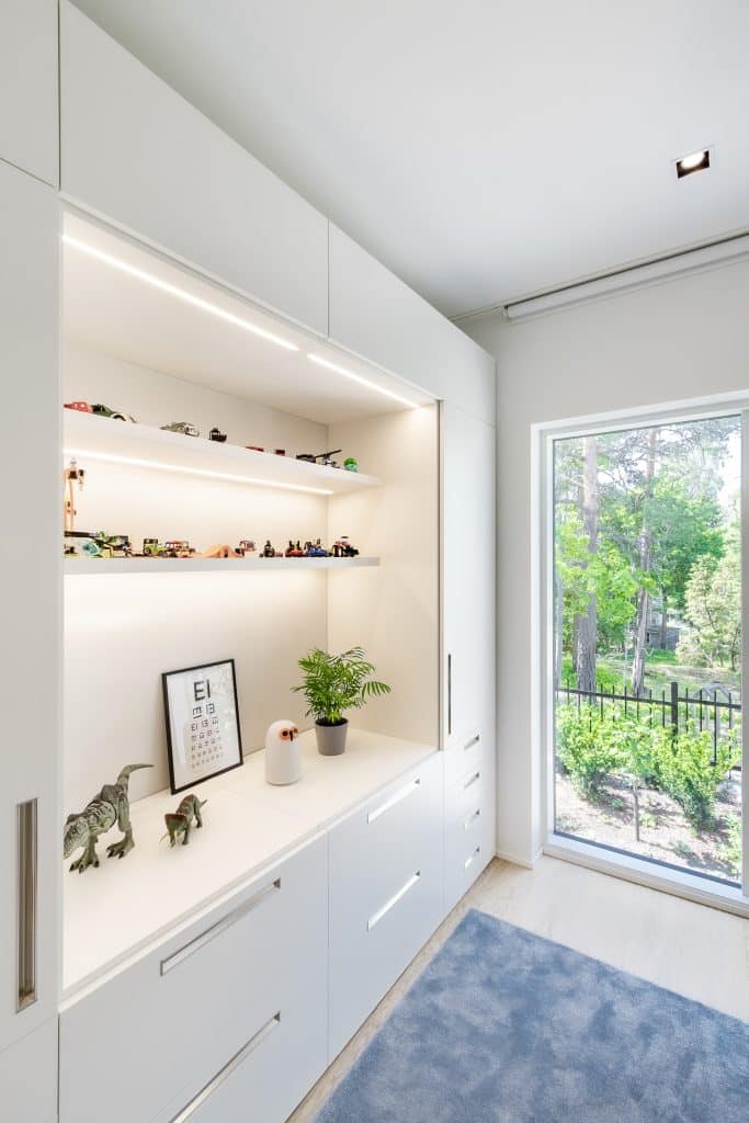 Valoisa huone, leluja ja kasvi.